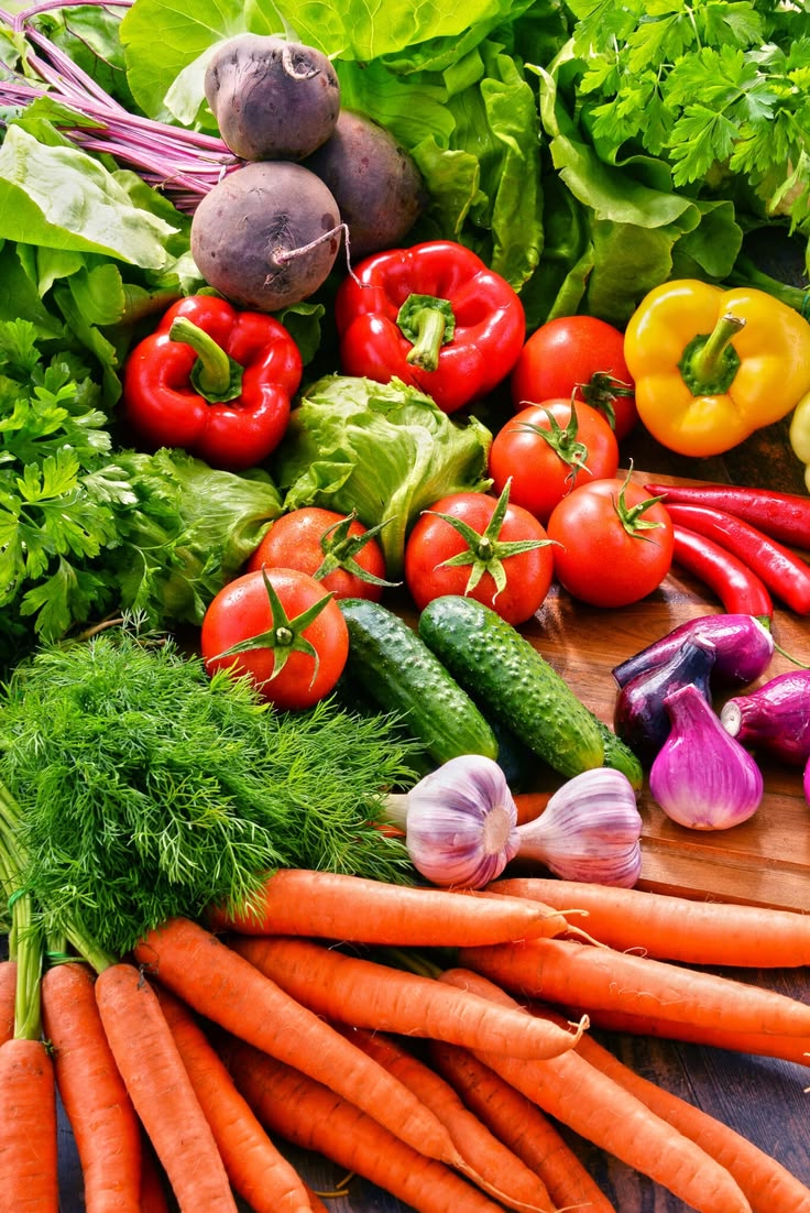 Fresh vegetables and herbs including tomatoes, cucumbers and carrots