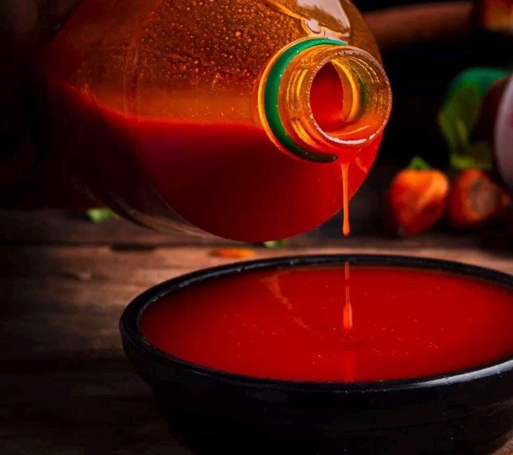Red palm oil being poured into a bowl