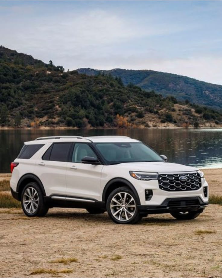 White Ford Explorer SUV by a lake